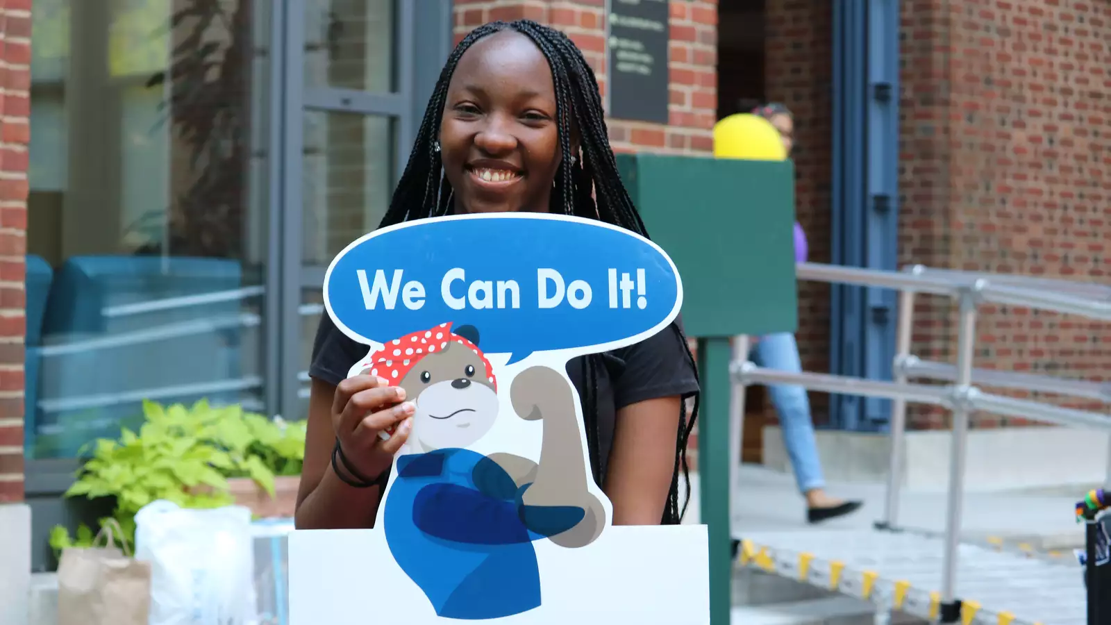 student with sign